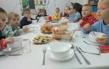 Uczniowie klasy pierwszej przy wigilijnym stole