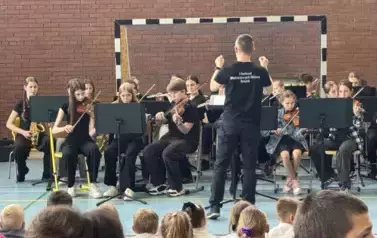 Dzieci z instrumentami muzycznymi grają koncert 