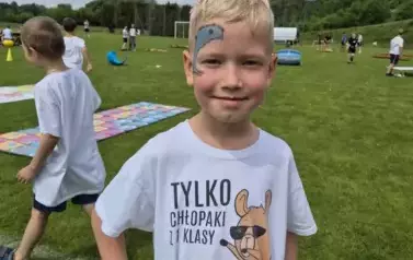 Chłopiec w sportowym stroju z pomalowaną twarzą