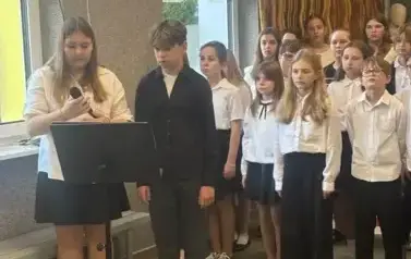 Uczniowie ubrani w stroje galowe recytują wiersze