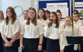 Uczennice śpiewają pieśń patriotyczną.