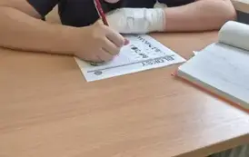 Chłopiec rozwiązuje zadania na kartce