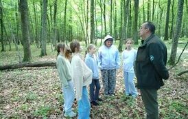Uczniowie stoją przy tablicy informacyjnej